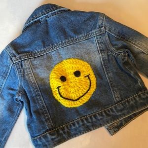 Baby Jean jacket with crochet smiley face